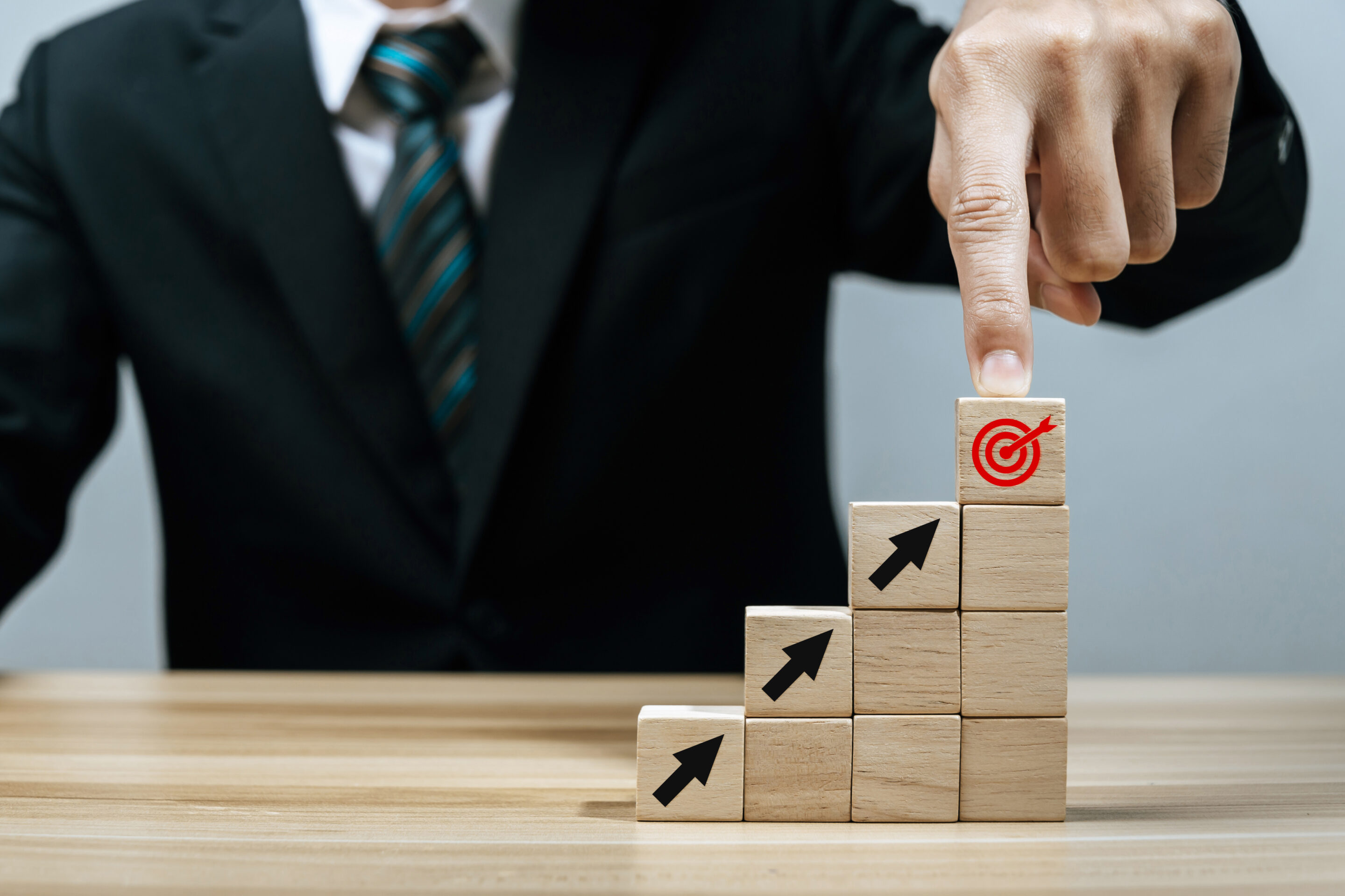 Goal. businessman investor hand pointing on red dart board and a